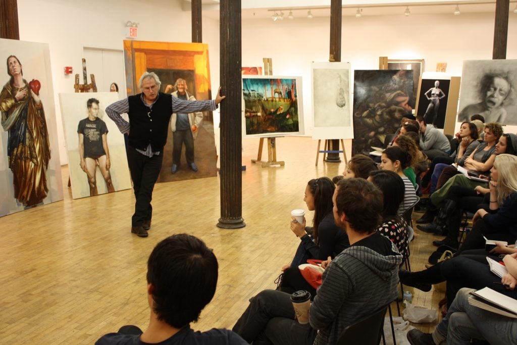An artist leads a critique session at an art school