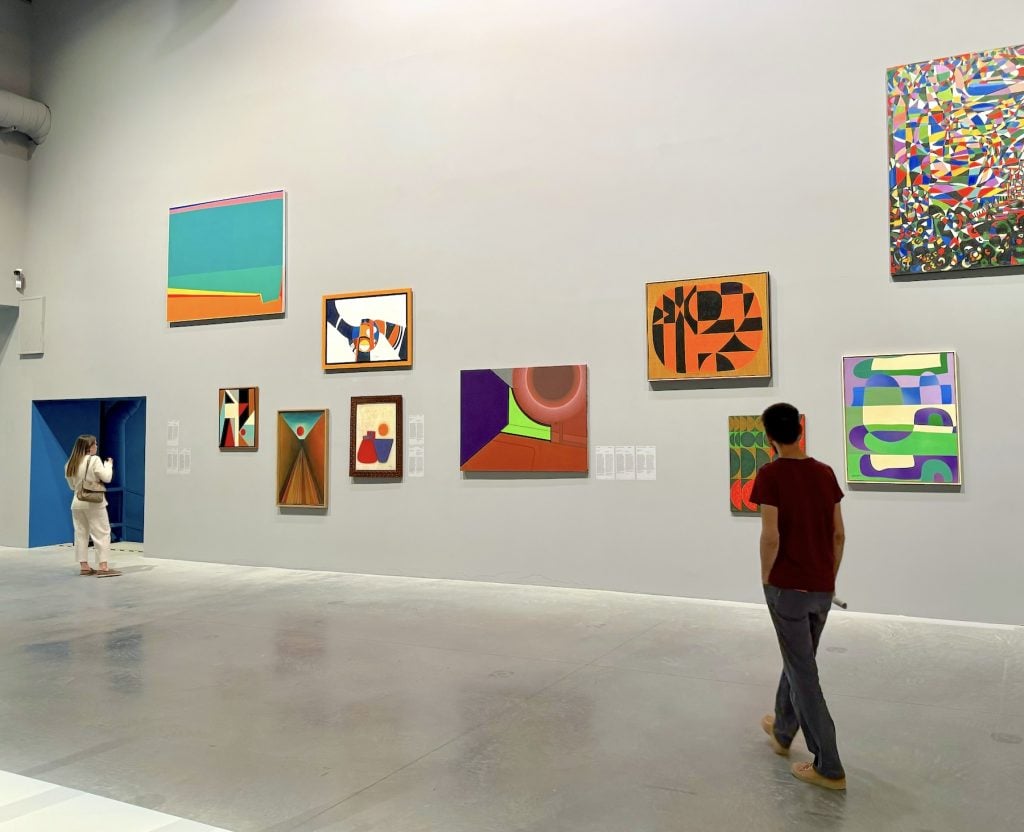 A gallery full of many abstract paintings