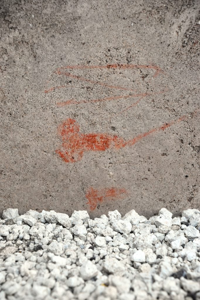 A faint drawing in ocher on a stone wall