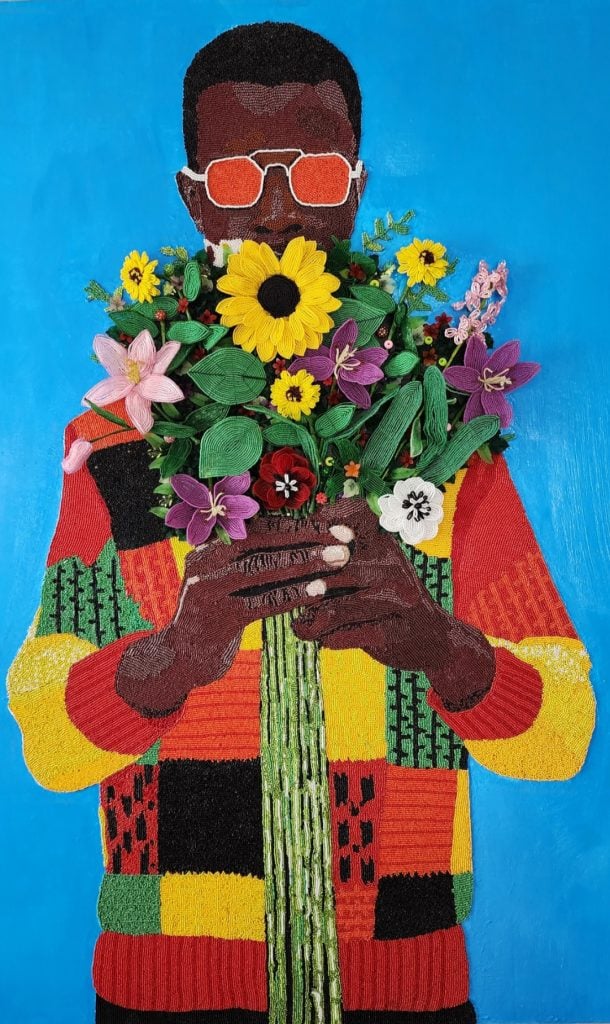 A painting of a black man wearing a colorful patchwork sweater holding a bouquet of mixed flowers in front of him, which partially obscures his face, over which he is wearing mirrored orange aviator sunglasses, standing against a monochrome light bright blue background, included in Selfless Art Gallery's pop-up exhibition in tribeca.