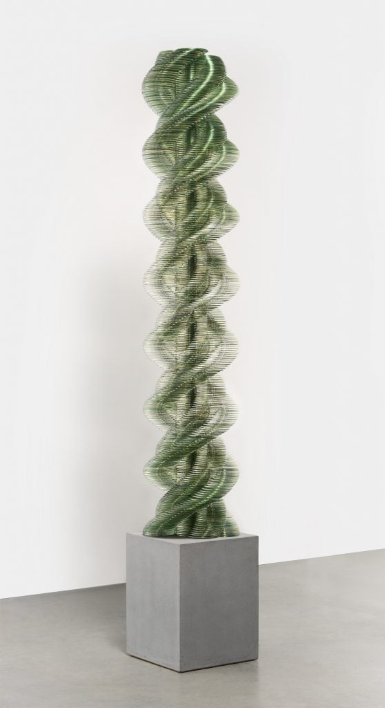 photograph of a helix shaped sculpture made out of cds by artist tara donovan