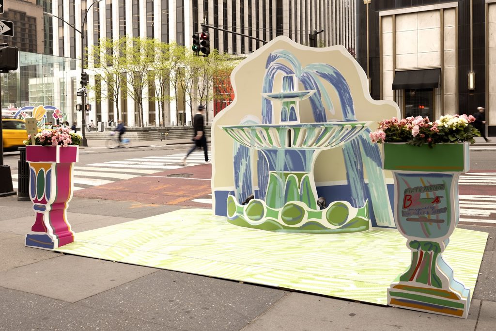 A sculpture of a fountain and two painted planters on Fifth Avenue in New York