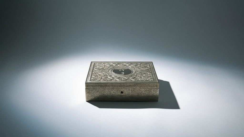 An ornately carved metal box