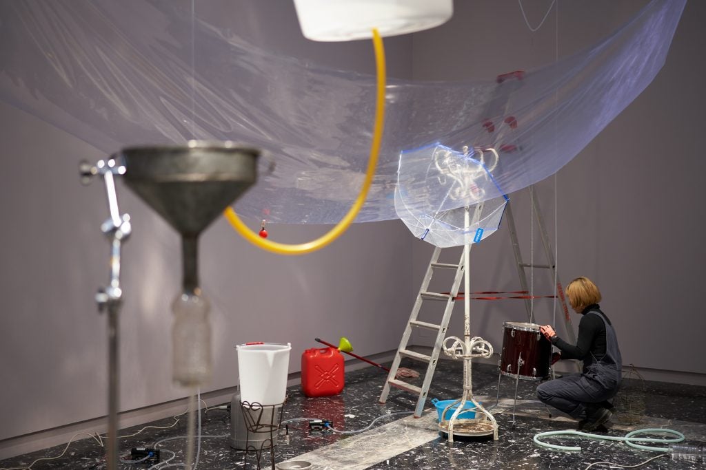 photograph of artist yuko mohri installing her sculptures