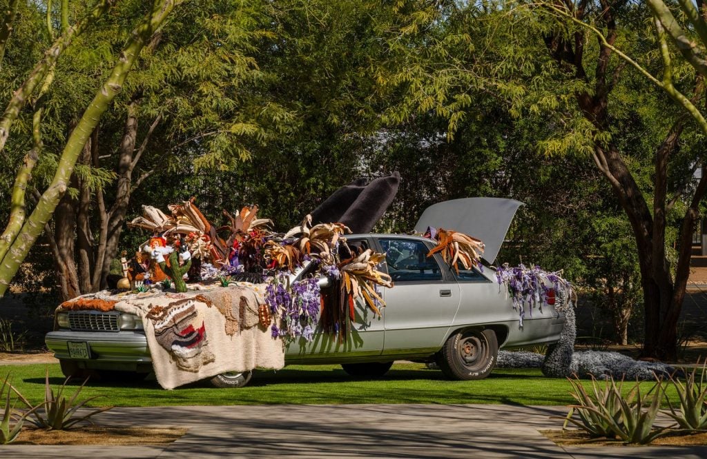 a car overflowing with flowers and textile works