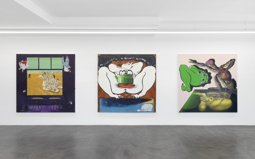 three large colorful paintings hang on a white wall
