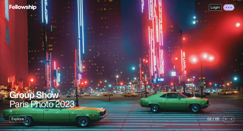 A futuristic city is seen on a dark night. Cars line the street.
