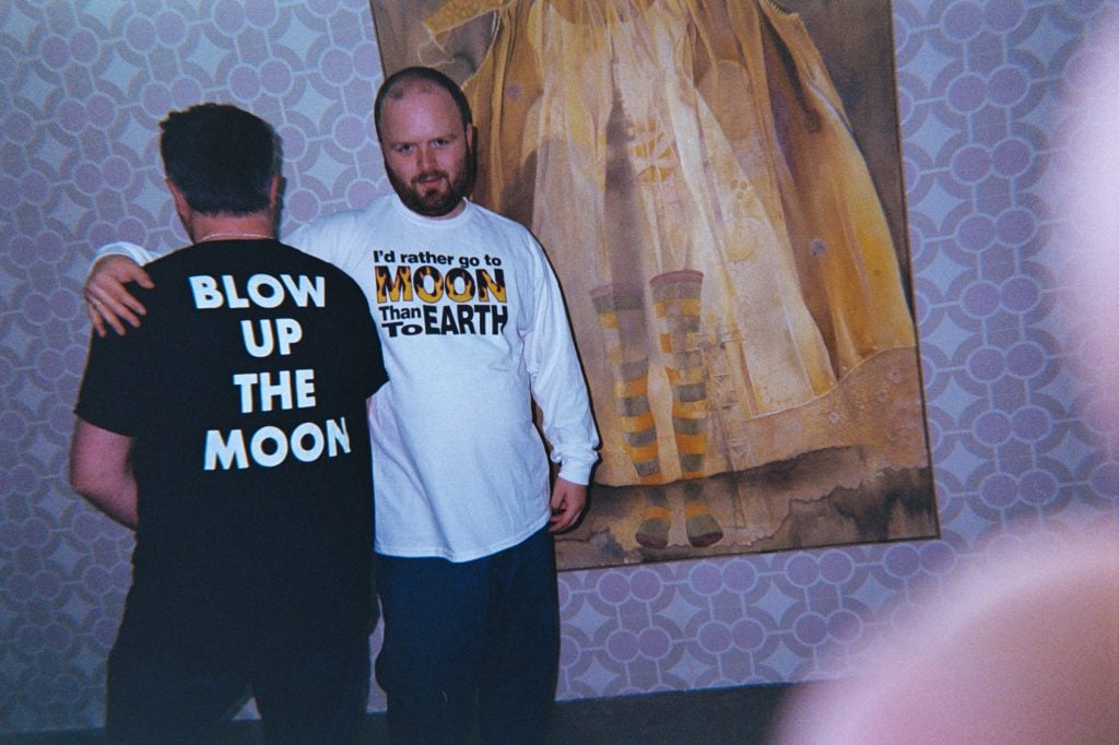 photo of two men with moon motif t-shirts