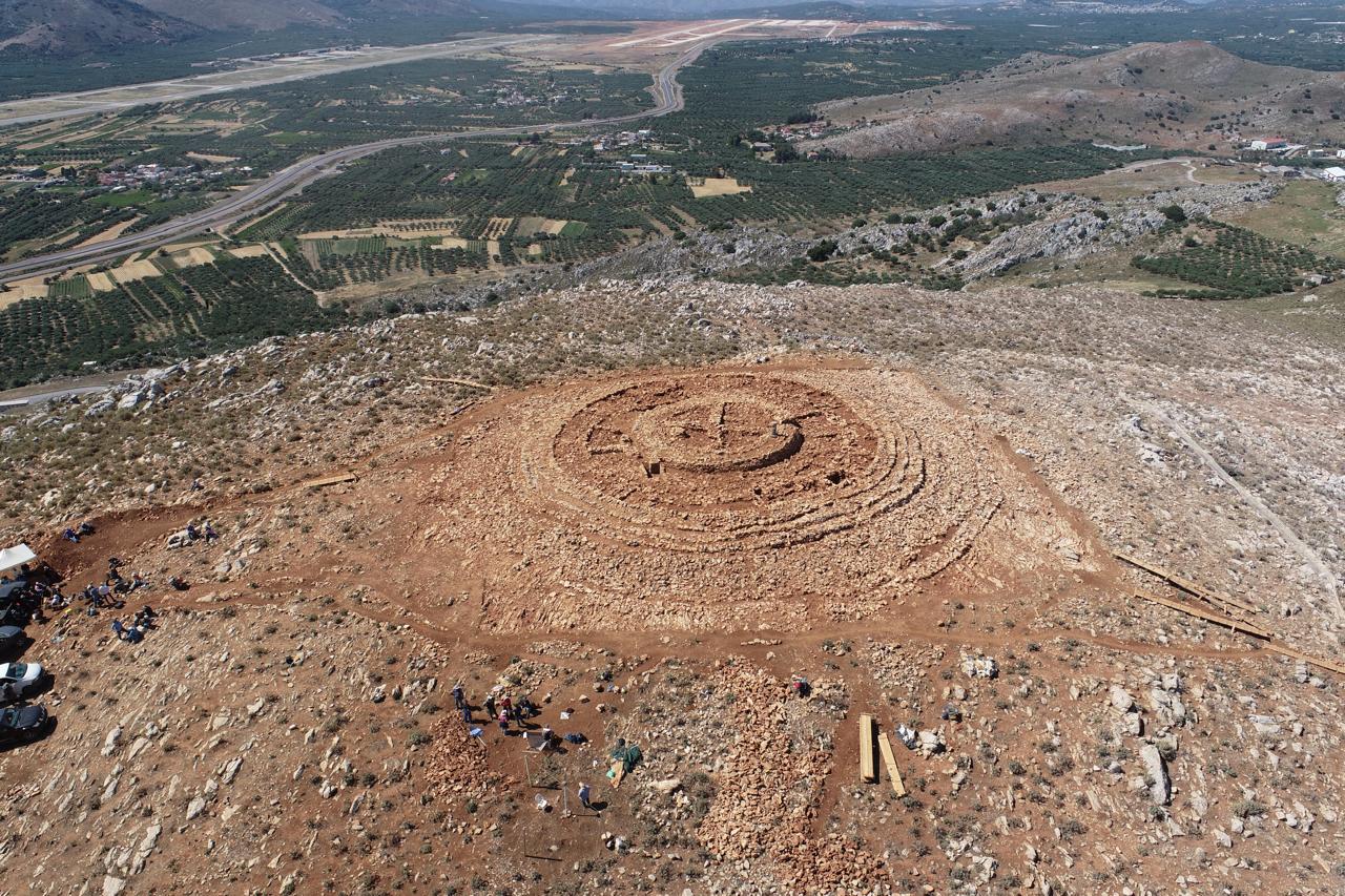 An ancient stone structure made up of concentric stone walls on a hilltop