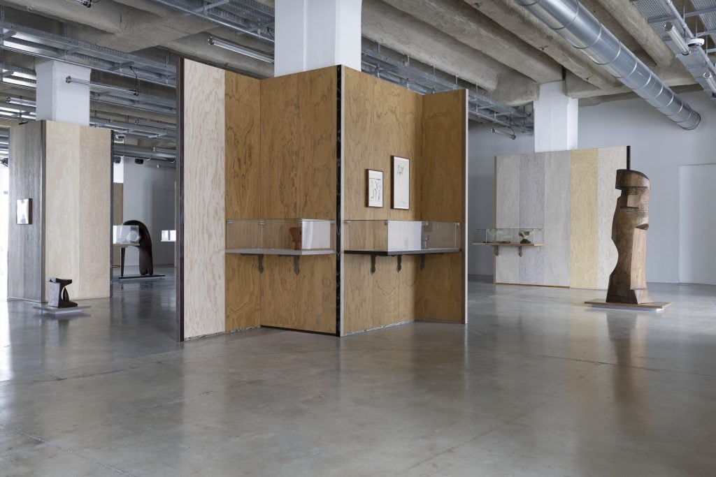 An art gallery with a specially constructed wood wall