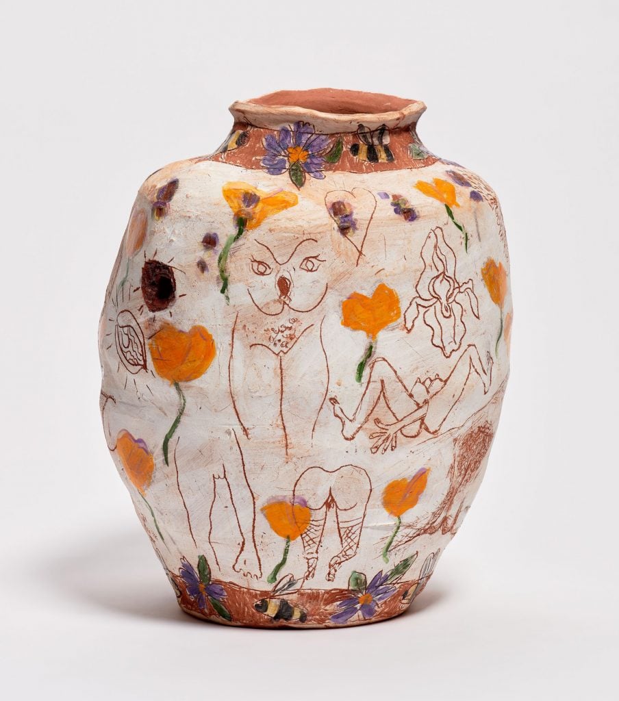 A terracotta pot by Jennifer Rochlin with sketched and etched on drawings of women's genitals interspersed with paintings of California poppies.