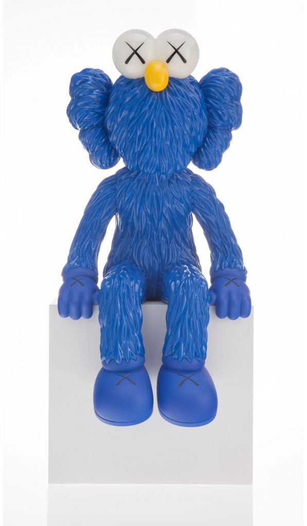 KAWS bff figure in blue sitting down on a plinth.