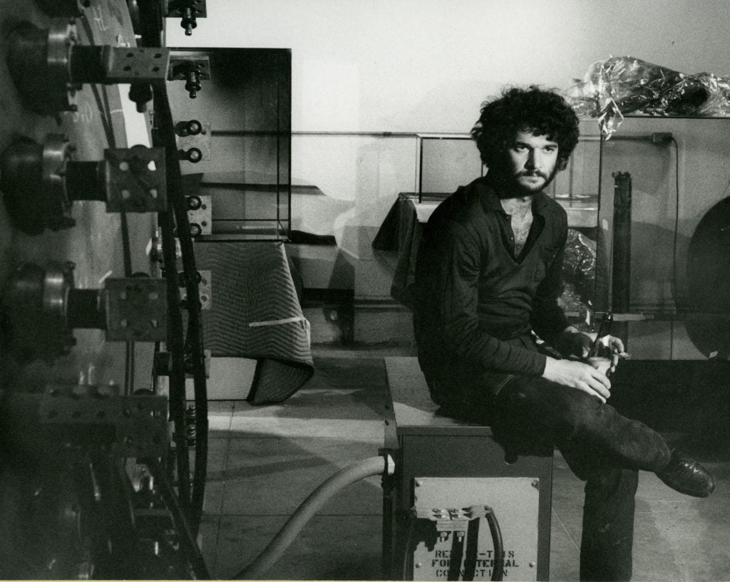 photograph of artist larry bell in black in white sitting