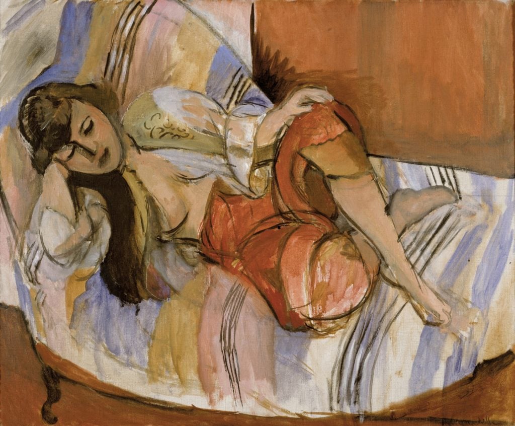 The image depicts a painting of a woman reclining on a striped bed. She is dressed in loose, colorful clothing, and her dark hair falls to one side as she rests her head on her hand. The brushstrokes are expressive, and the overall composition is characterized by bold, flowing lines and vibrant colors.
