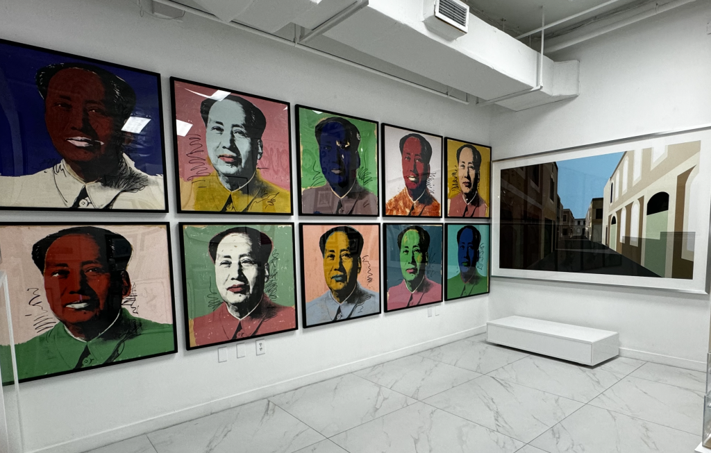 A view inside Miami Fine Art Gallery space with a grid of Andy Warhol Mao prints along the wall and a large-scale photograph on the opposite wall.