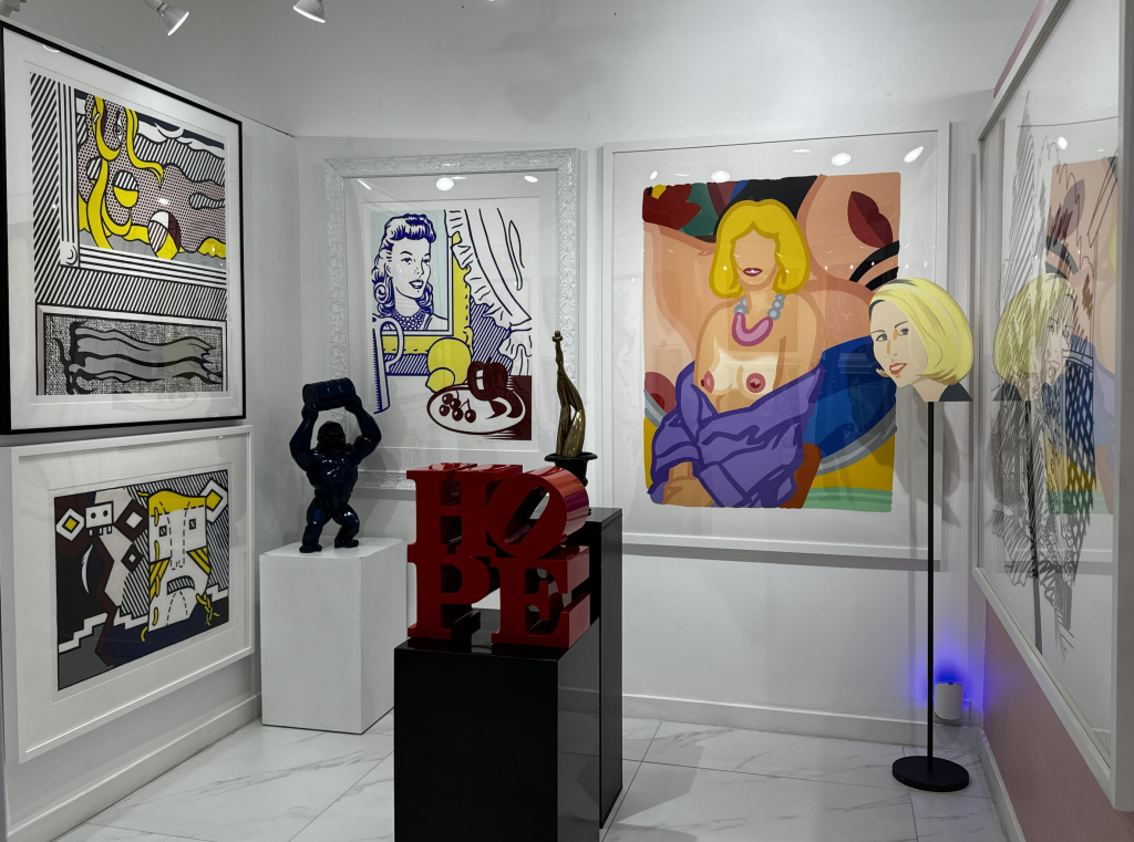 View inside Miami Fine Art Gallery with various prints installed on the three walls and miscellaneous sculptures installed around the space.