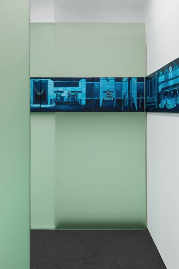 photograph of frosted green glass with panels of paintings mounted on it