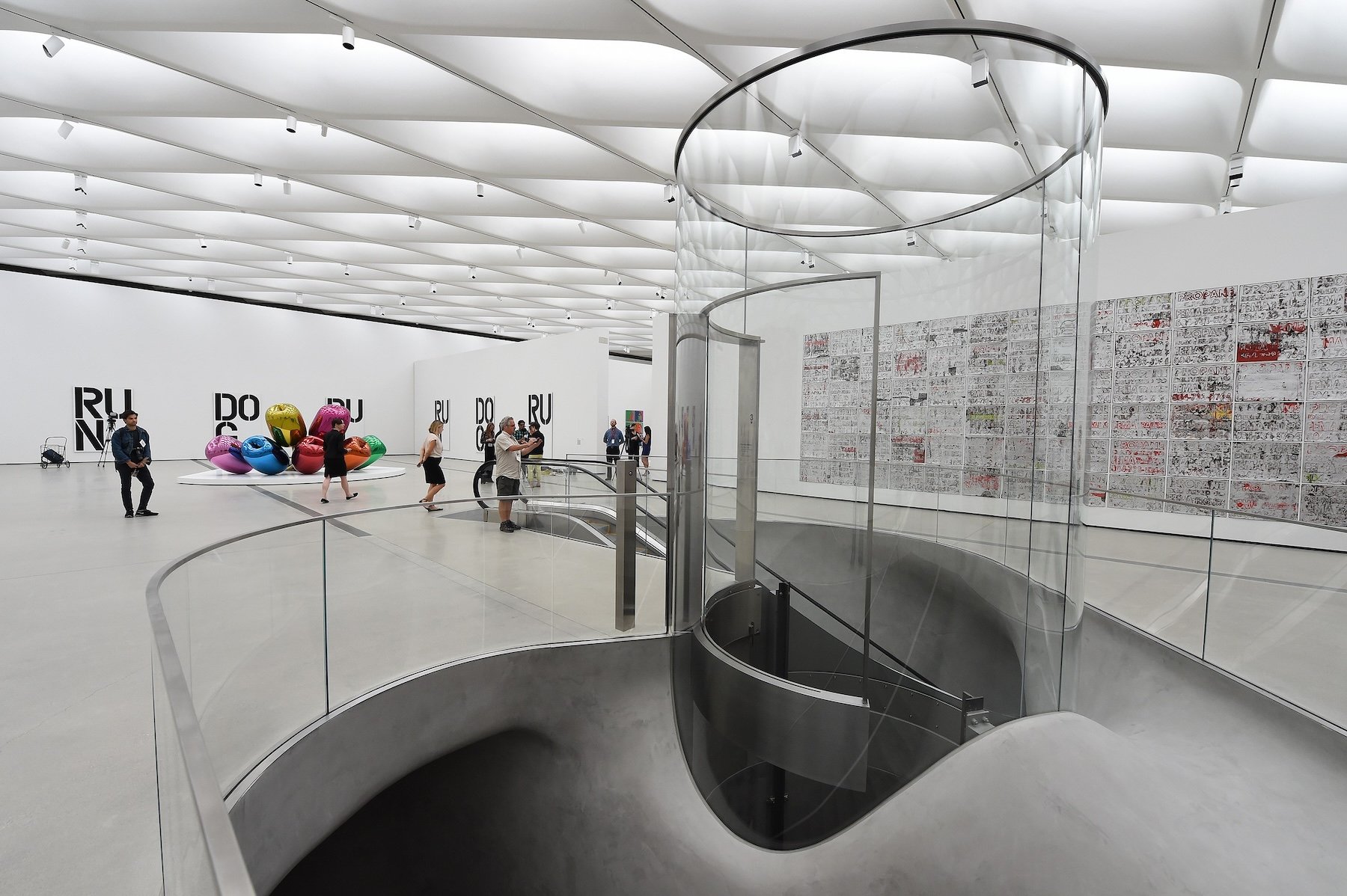 A glass cylinder entrance in an art gallery