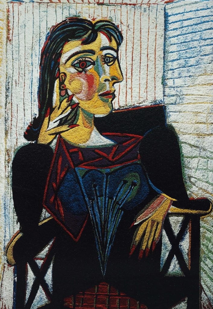 Cubist portrait of a woman sitting in a chair by Vik Muniz done in the style of Picasso.