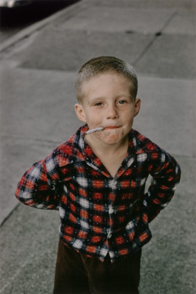 A small boy smoking a cigarette