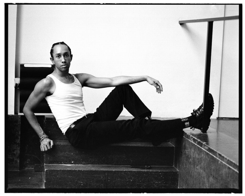 portrait of artist miles greenberg sitting on a step 