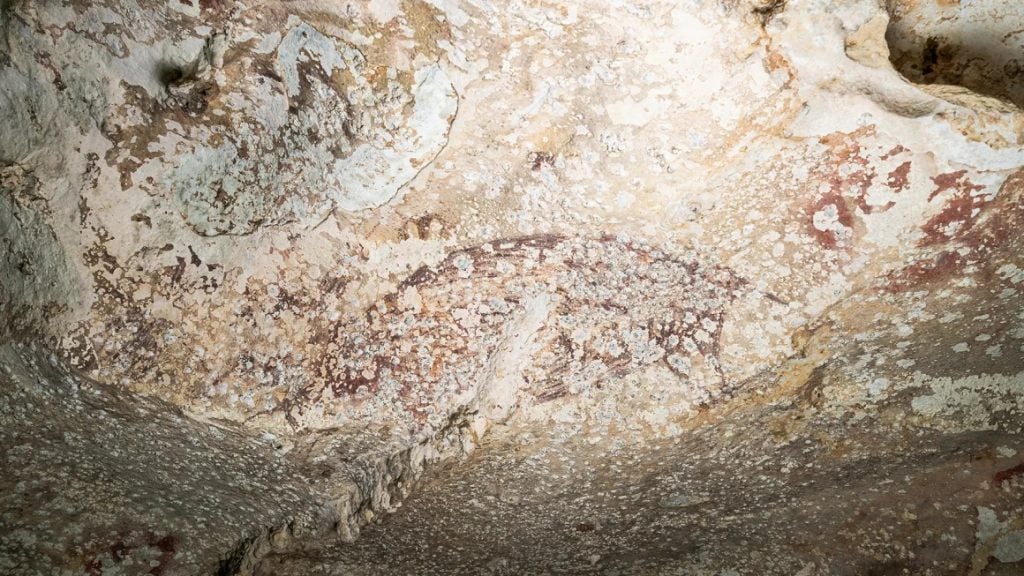 a photo of a rock ceiling with faint traces of painting