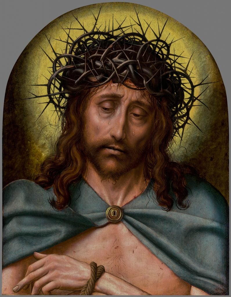 Quentin Metsys's Flemish Renaissance painting Christ as the Man of Sorrows, a tightly cropped portrait of Christ, hands bound and shirtless with a blue cape, wearing a crown of thorns and crying against a golden background. 