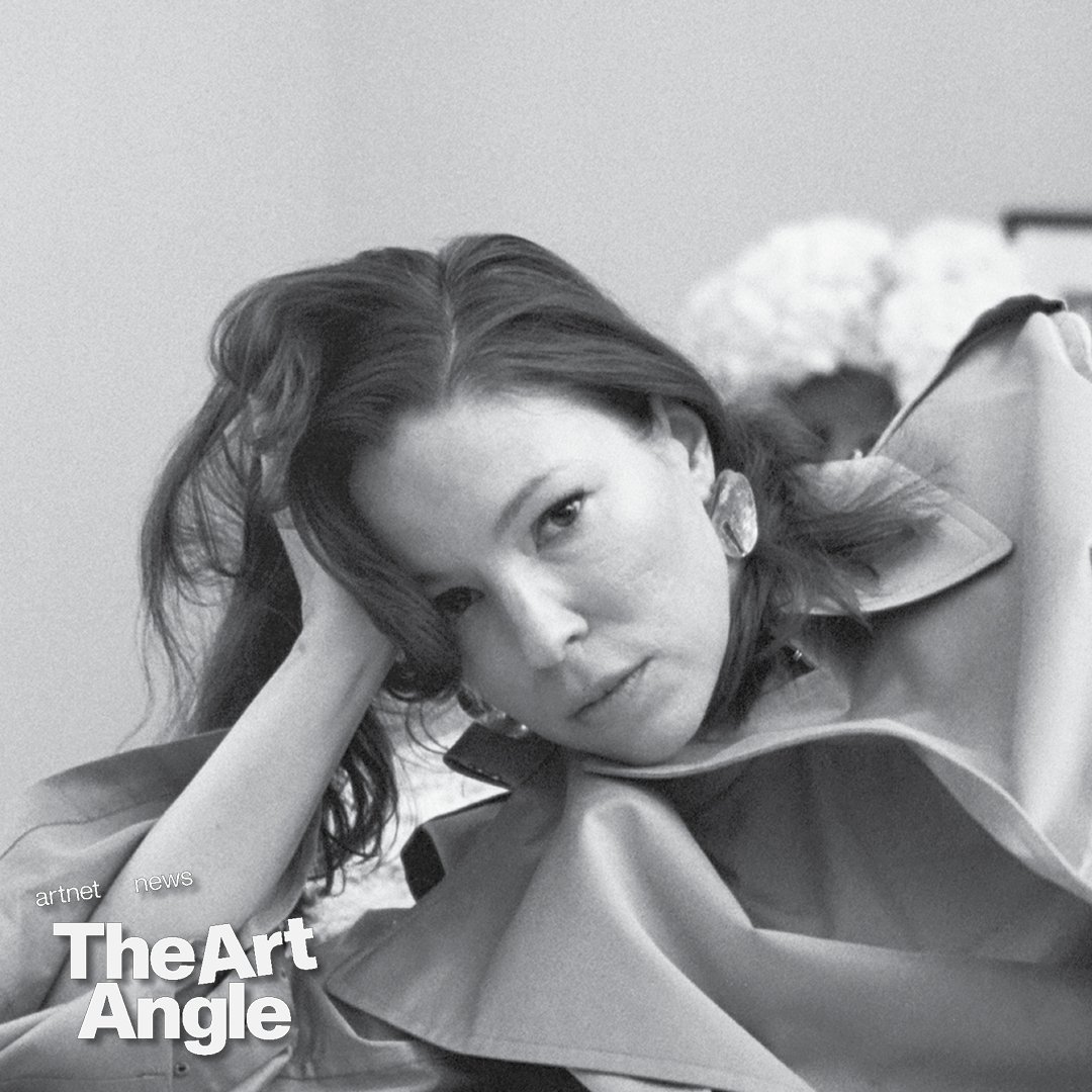 a black and white portrait of a white woman laying down with her hand propping up her head