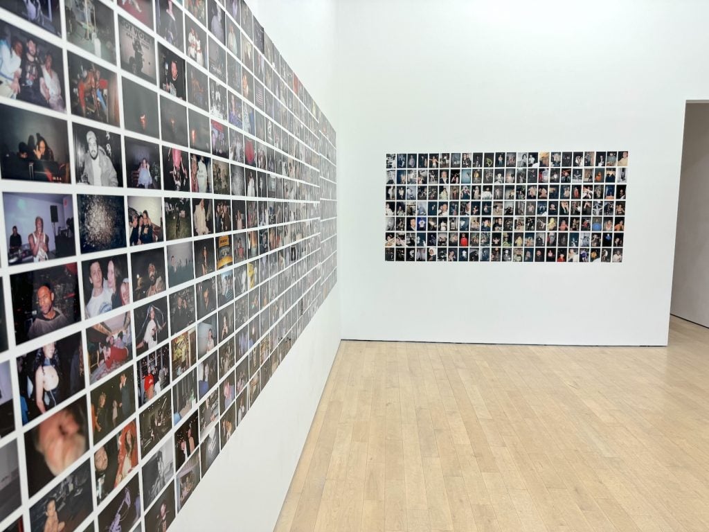 A gallery with a wall crowded with photos
