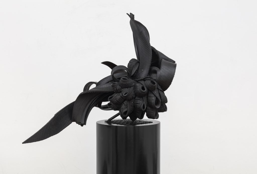 a black sculpture made of rubber.