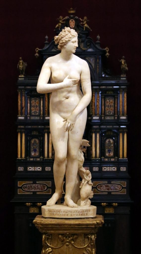a marble sculpture of a nude woman