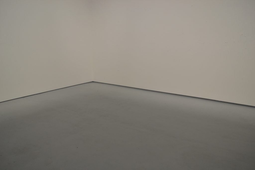 A photo shows a gallery with white walls