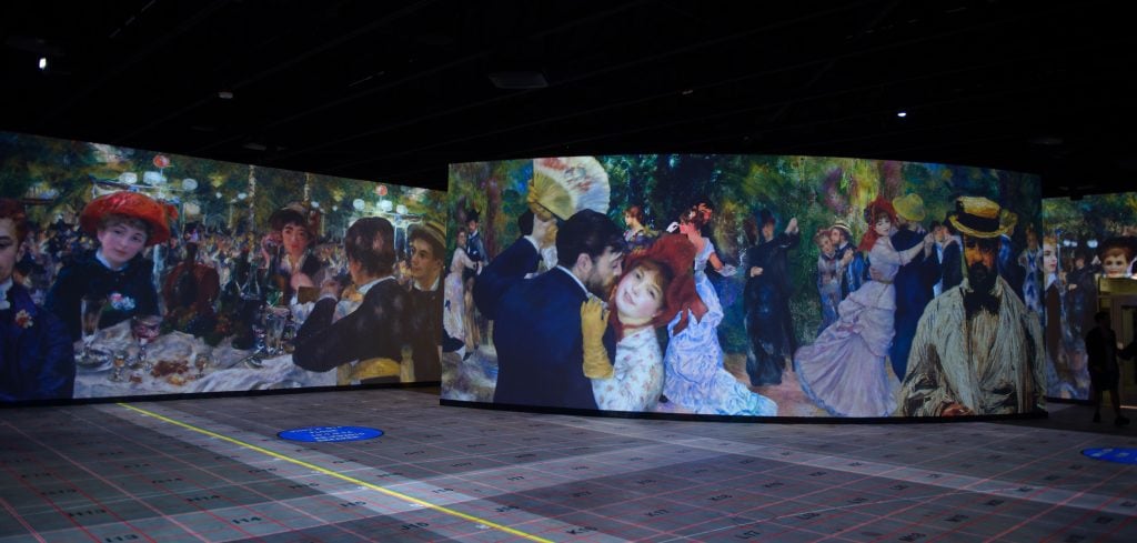 an installation view of an upcoming exhibition at the Museum of Art and Light showing Renoir paintings on large horizontal surfaces.