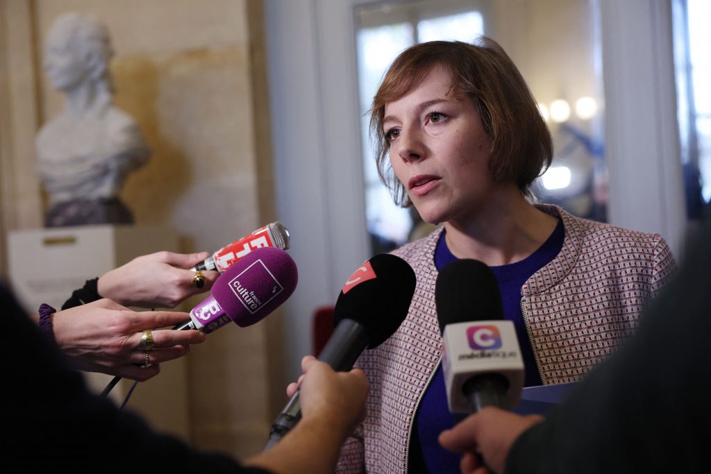 a woman speaks into several microphones