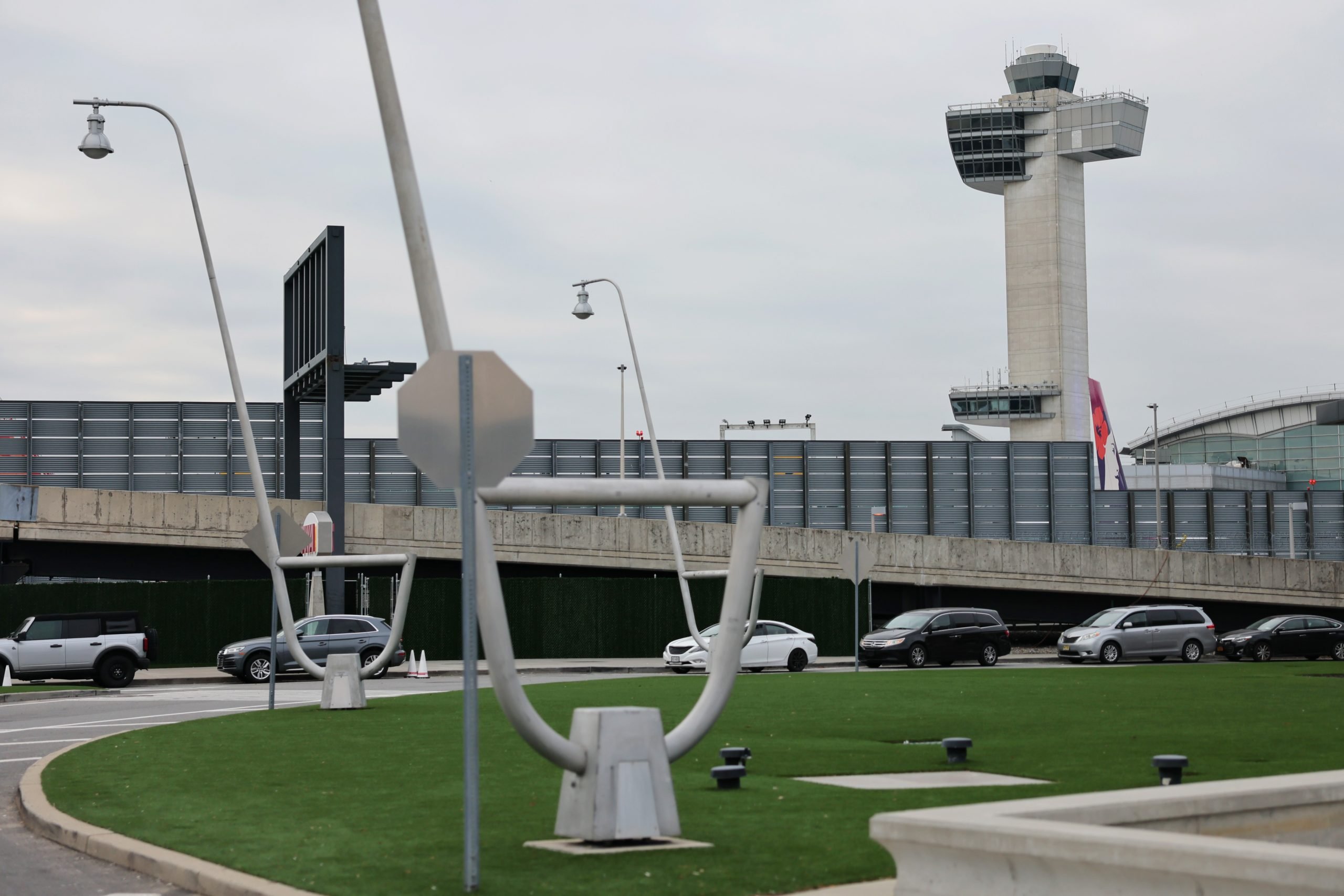 A color photo shows an airport on a cloudy day.