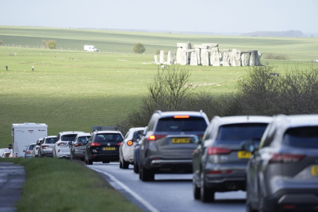 a photo of traffic along the A303 highway past Stonehenge in rural england