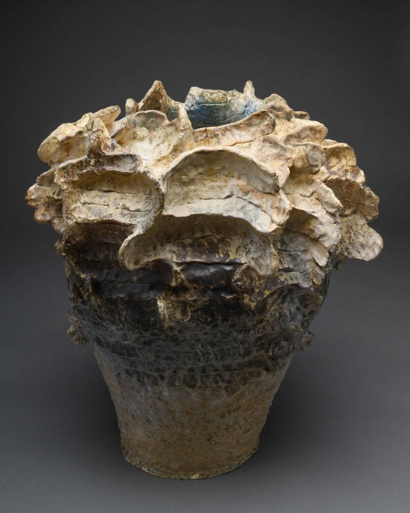 A sculpture with a rugged, textured surface, resembling a natural rock formation.