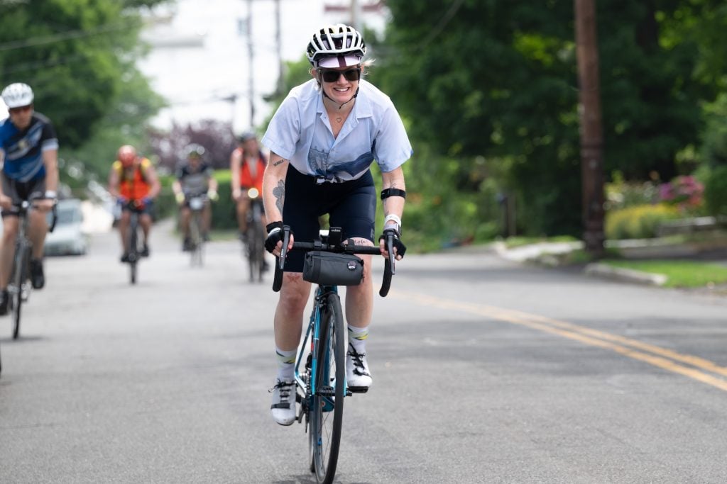 a woman on a bike with a white helmet
