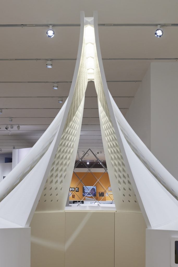 A model of a building in white on view at an exhibition