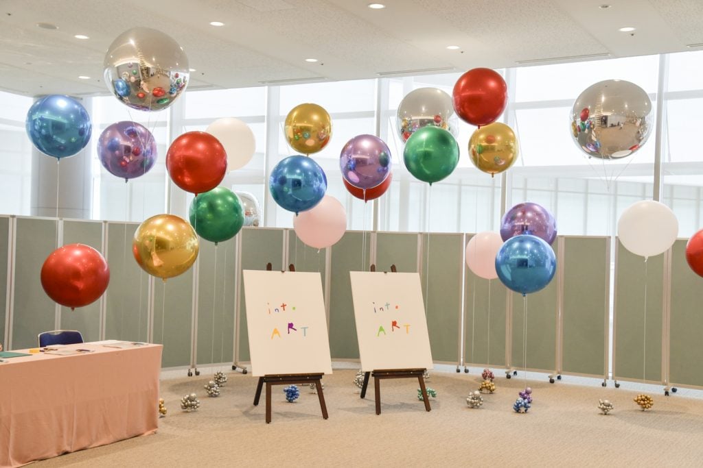 Lots of colourful balloons and two canvas on easels