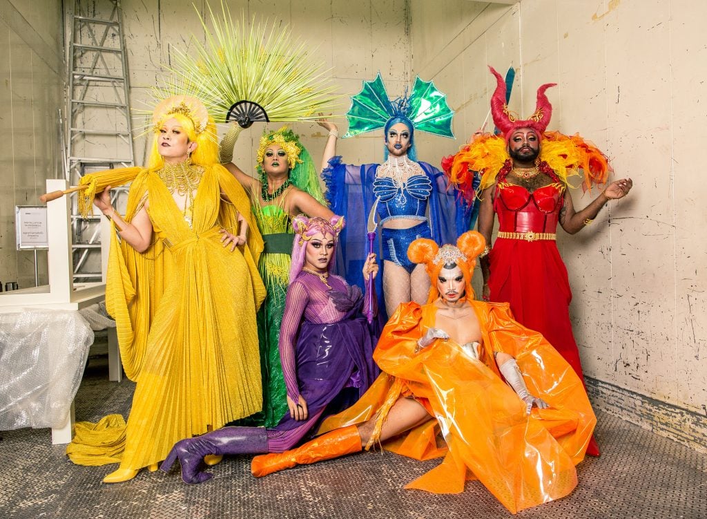 A group of performers in colorful costumes.