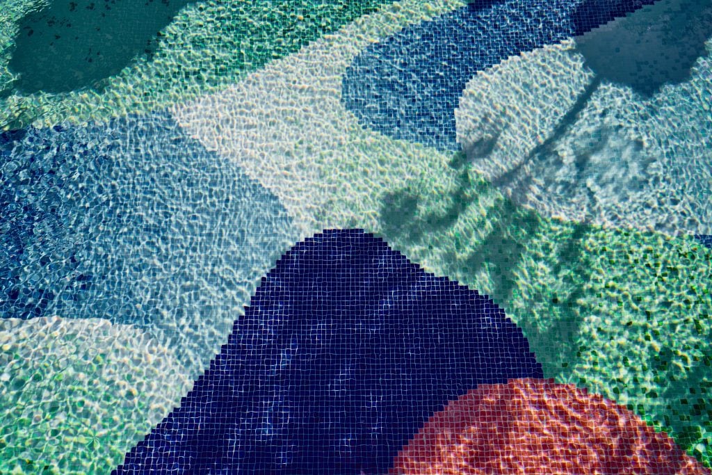 a closeup of an artistic mosaic-tiled pool 
