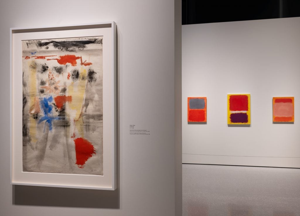 installation view of Rothko's surrealist work and color field paintings in warm tone