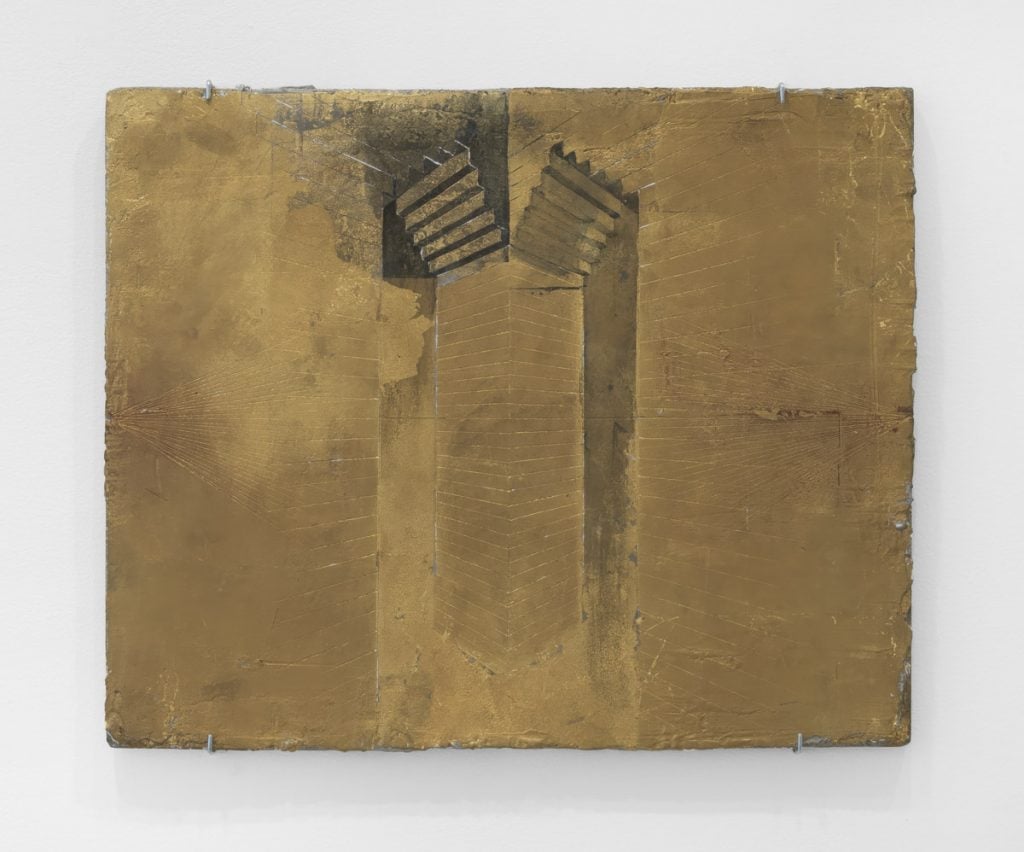An abstract work on gold leaf has carved lines that suggest a geometric form 