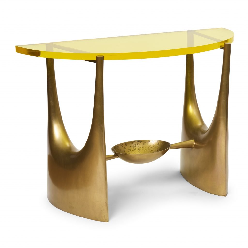 A gold console with a glass top