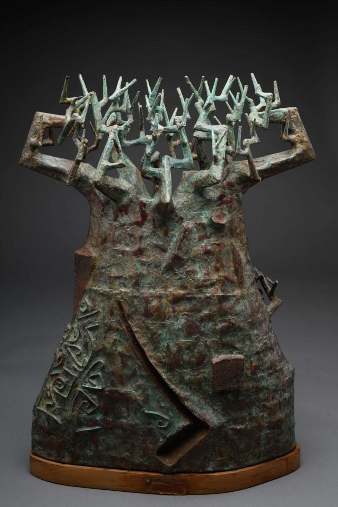 A bronze sculpture representing a tree with intricate, angular branches and textured surface.