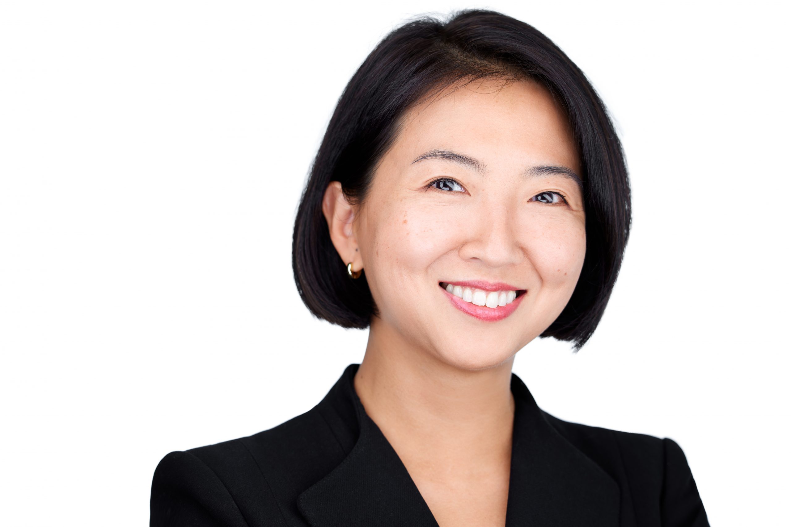 A color photo shows a woman against a white background