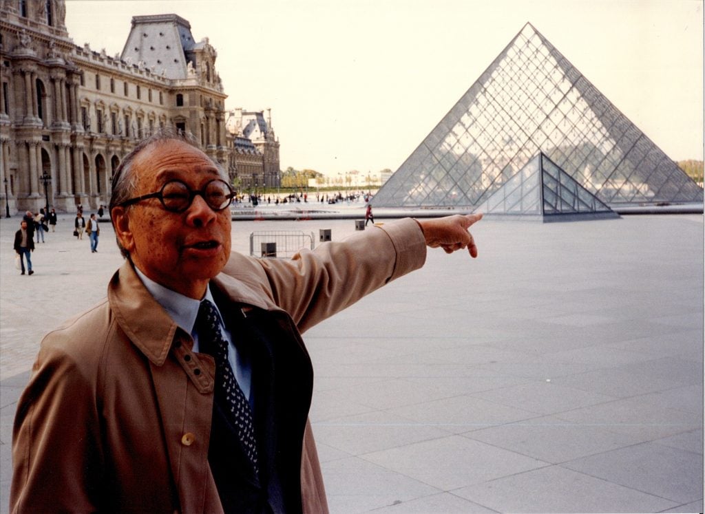 Chinese-American architect I.M. Pei, pointing at the famed glass pyramid he built at Louvre in Paris