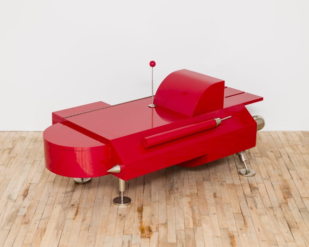 a coffee table is designed to look like a red retro futuristic race car
