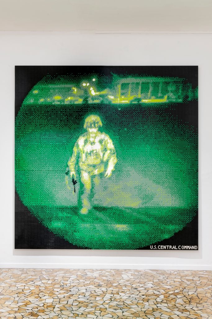 View through night vision scope in greens and yellows of a soldier walking forward, made entirely out of legos.